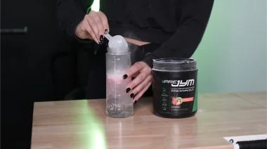 A person scooping pre-workout.
