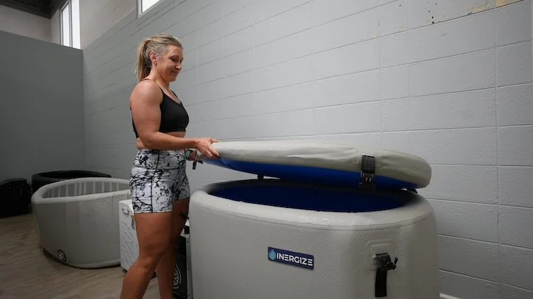 Our tester opening the top lid of the Inergize Cold Plunge: Elite Tub
