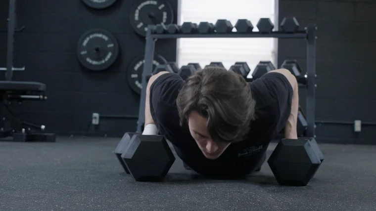 A BarBend tester doing Push-ups with the REP Fitness Hex Dumbbells.