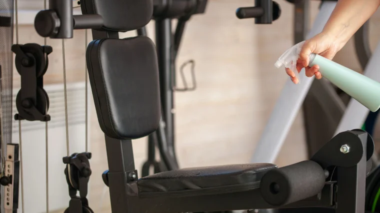Cleaning a cable machine in the home gym.