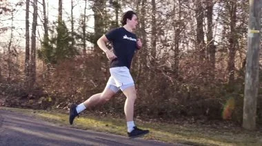 A person running outside to burn calories.