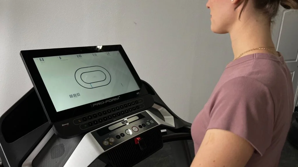 A BarBend product tester is shown using the HD touchscreen on the ProForm Pro 9000.