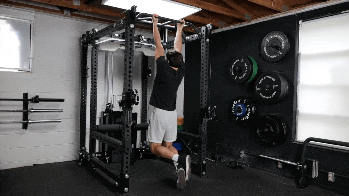 A person doing a chin-up using a pull up bar.