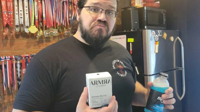 Our tester holding a box of ARMRA Colostrum travel packs