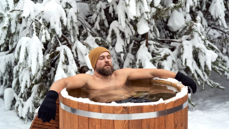 A person in a tub of ice cold water.