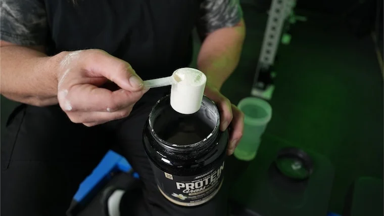 Our tester grabbing a scoop of Onnit Grass-Fed Protein