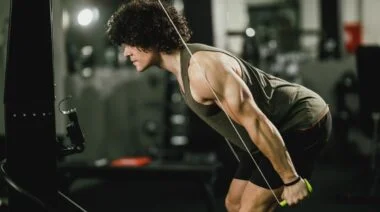 A closeup of a person on a ski erg machine.