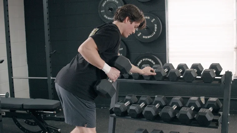 Jake Bracing Against the REP Fitness Dumbbell Storage Rack for Dumbbell Rows