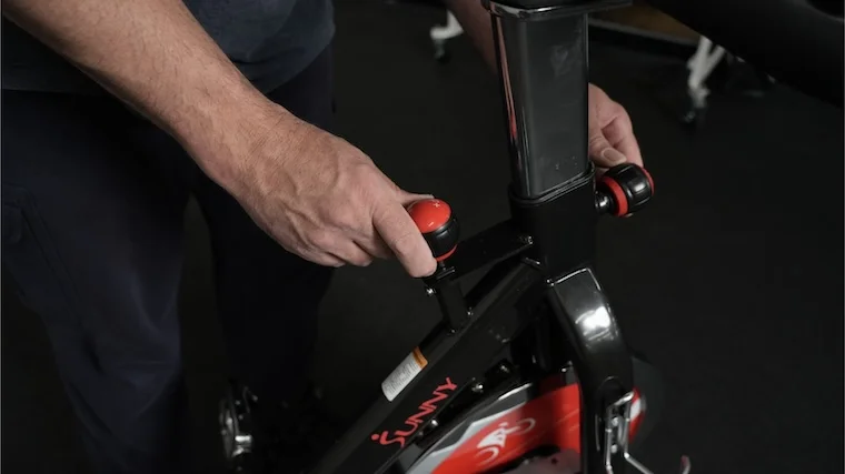 Our tester adjusting the resistance across the Sunny Health and Fitness SF-B1002 exercise bike