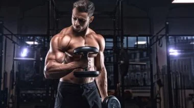 A bodybuilder working out with dumbbells.