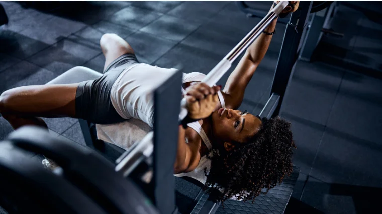 A person doing bench press exercise at the gym