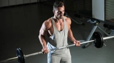A bodybuilder doing drag curls.
