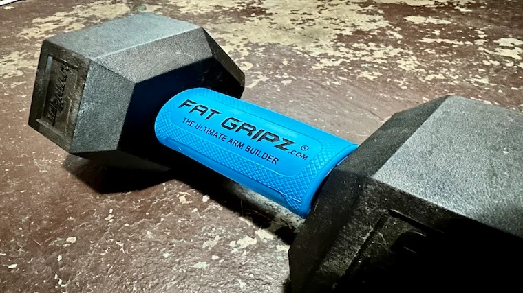 The Fat Gripz Pro Grip Strengthener set over a dumbbell handle