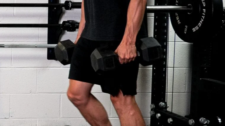 Jake gripping the dumbbells during an exercise.