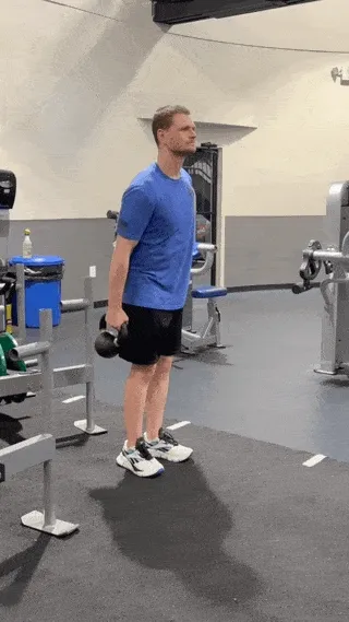 A person performing the bottoms-up kettlebell carry.