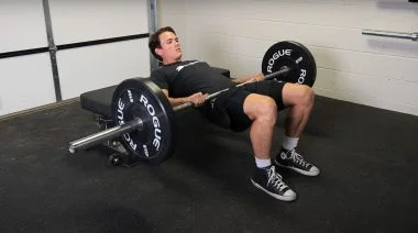 A person performing the hip thrust exercise.