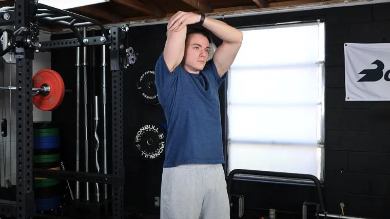 A person performing the overhead tricep stretch.