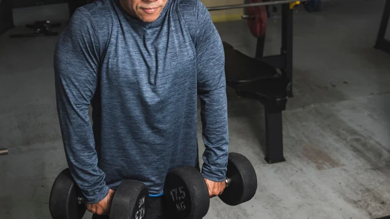 An athlete doing the dumbbell shrug.