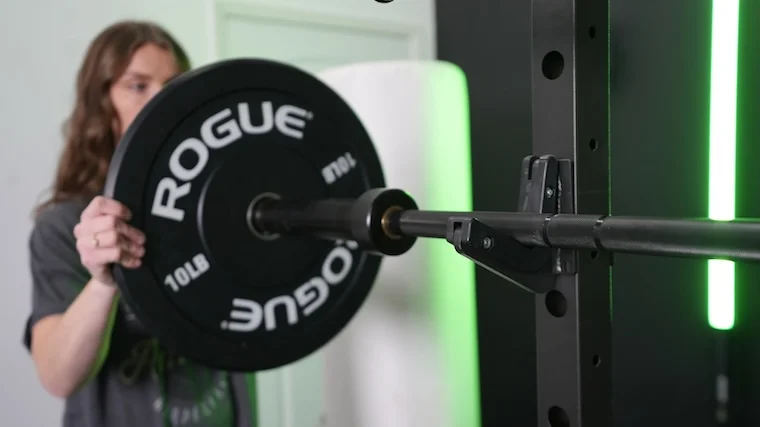 Our tester loading the Major Fitness 20kg 7’ Home Gym Barbell.