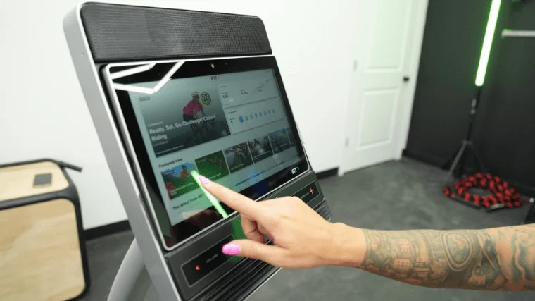 Our tester scrolling through the iFIT library on the NordicTrack Commercial R35 recumbent bike