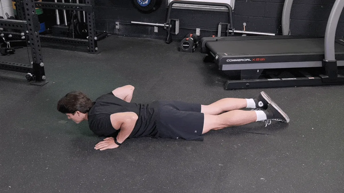 Jake demonstrating the pilates roll-up movement.