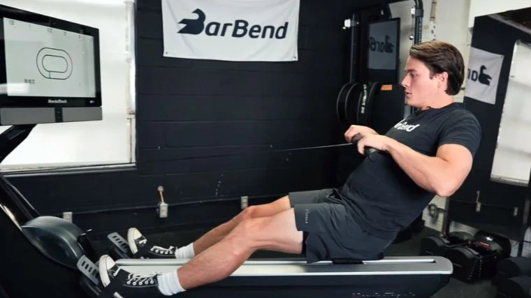 A person doing a rowing machine workout for weight loss.