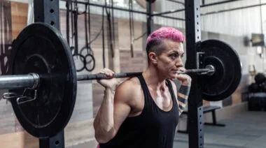 A person sets up for a back squat.