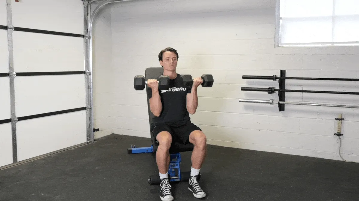 BarBend's Jake Herod performing the arnold press exercise.