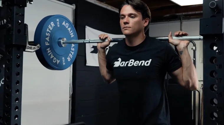 squatting with the again faster pursuit olympic bar