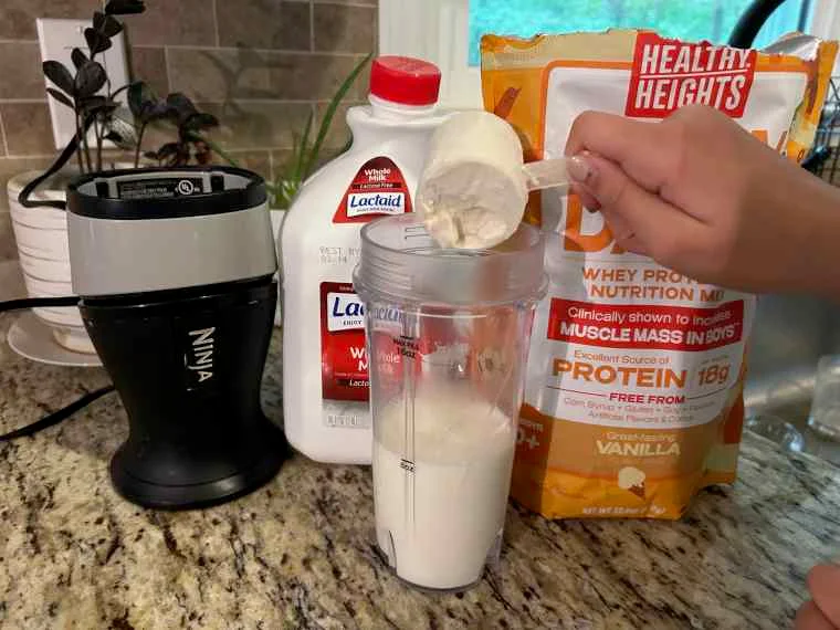 Pouring a scoop of Healthy Heights Grow Daily Protein Powder