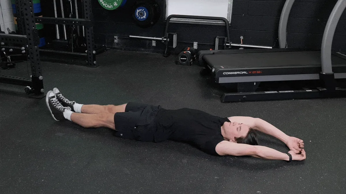 Jake demonstrating the pilates roll-up movement. 