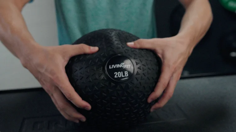Gripping the 20-Pound Living.Fit Slam Ball