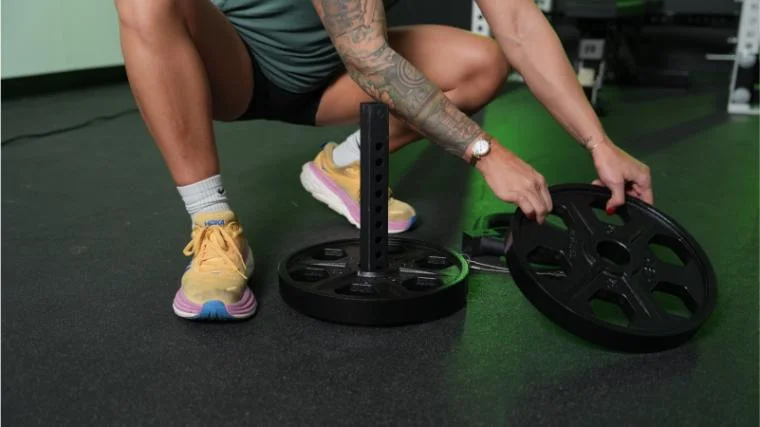 Our tester loading the Titan Fitness Plate Loadable Kettlebell Swing.