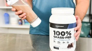 a person shaking up protein powder