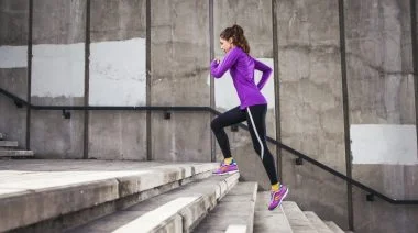 A fit person running on the stairs.