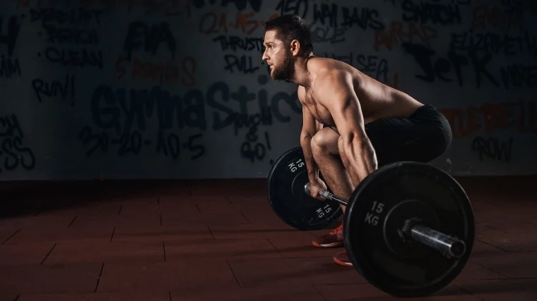 man deadlifting barbell