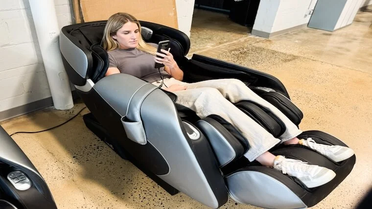Our tester adjusting the settings on the Relaxe Zero-Gravity Shiatsu Massage Chair