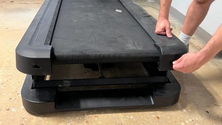 Our tester adjusting the tension of the belt on the NordicTrack x32i Treadmill.