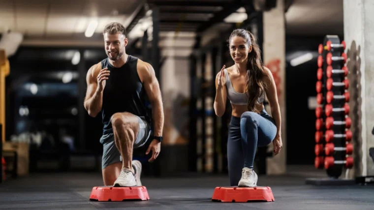 Two fit people perform lunges