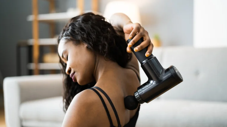 A person using a massage gun