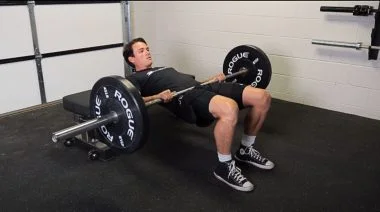 A person performing the hip thrust exercise.