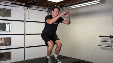 A person performing the box jump exercise.