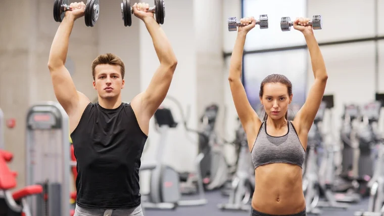 People doing a standing shoulder press.
