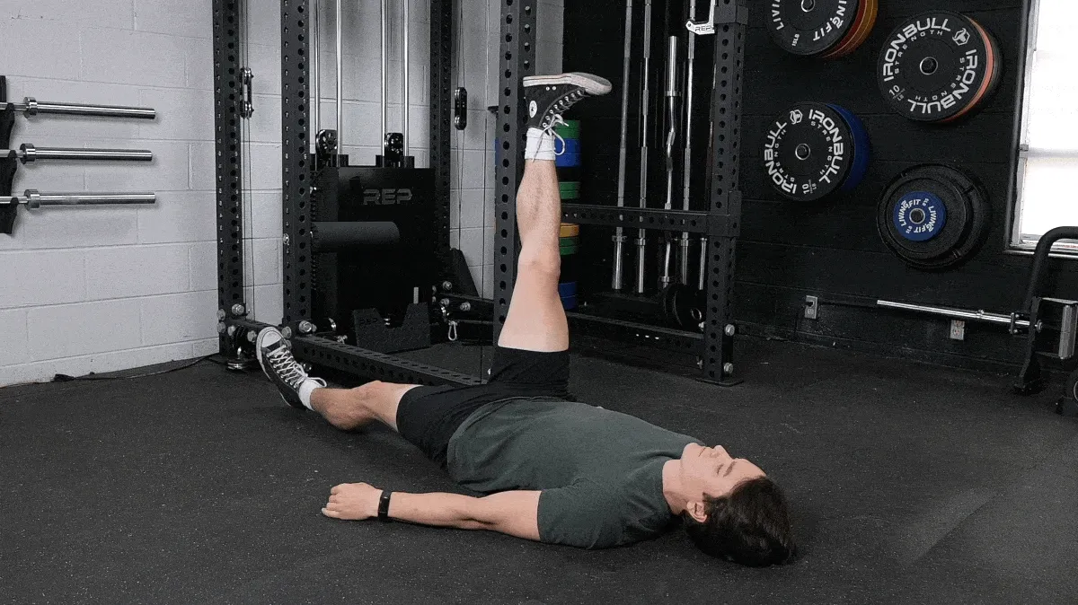 A person doing the single-leg supine leg raise.