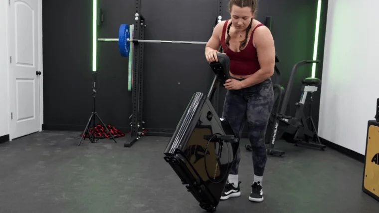 Our tester moving the Sharper Image Space Saving Stationary Bike into position for a workout