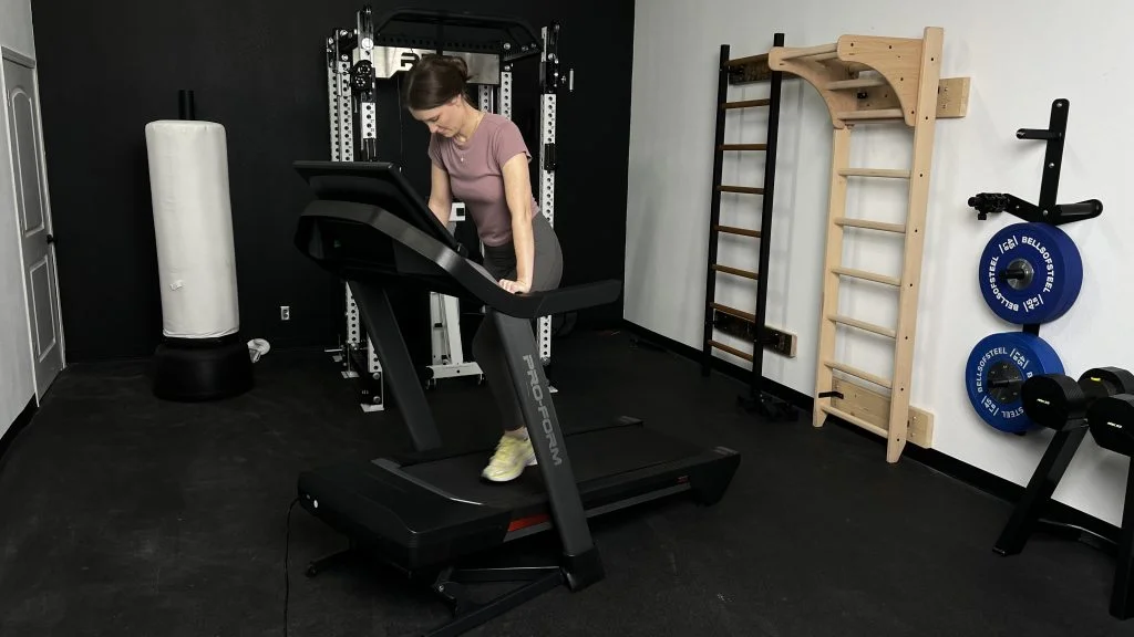 Our BarBend Tester adjusting the incline on a ProForm Pro 9000.