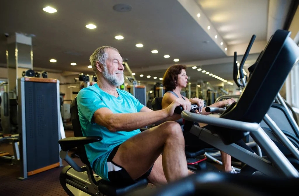 Senior athletes riding recumbent bikes.