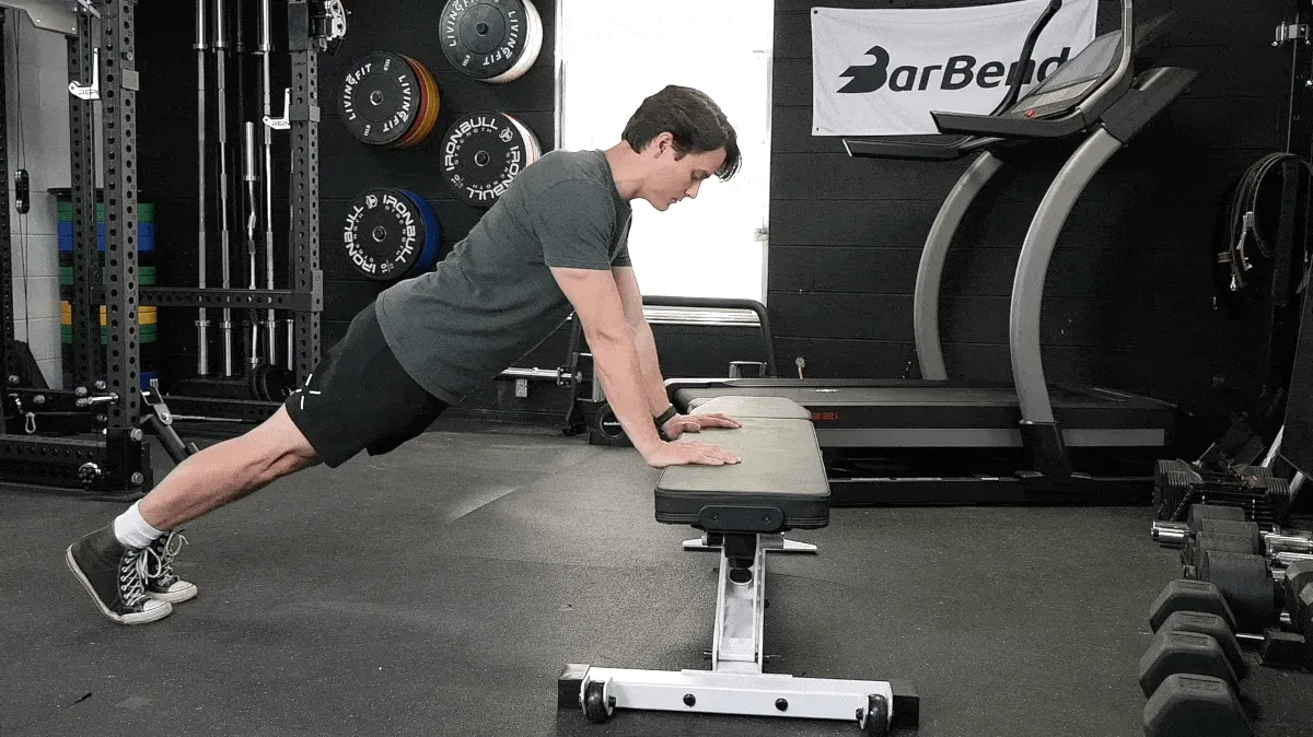 BarBend's Jake Herod performing incline push-ups.