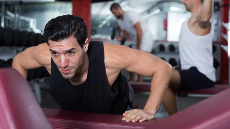 A person descending during an incline push up.