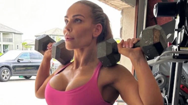 Natalya Neidhart performs dumbbell overhead presses.